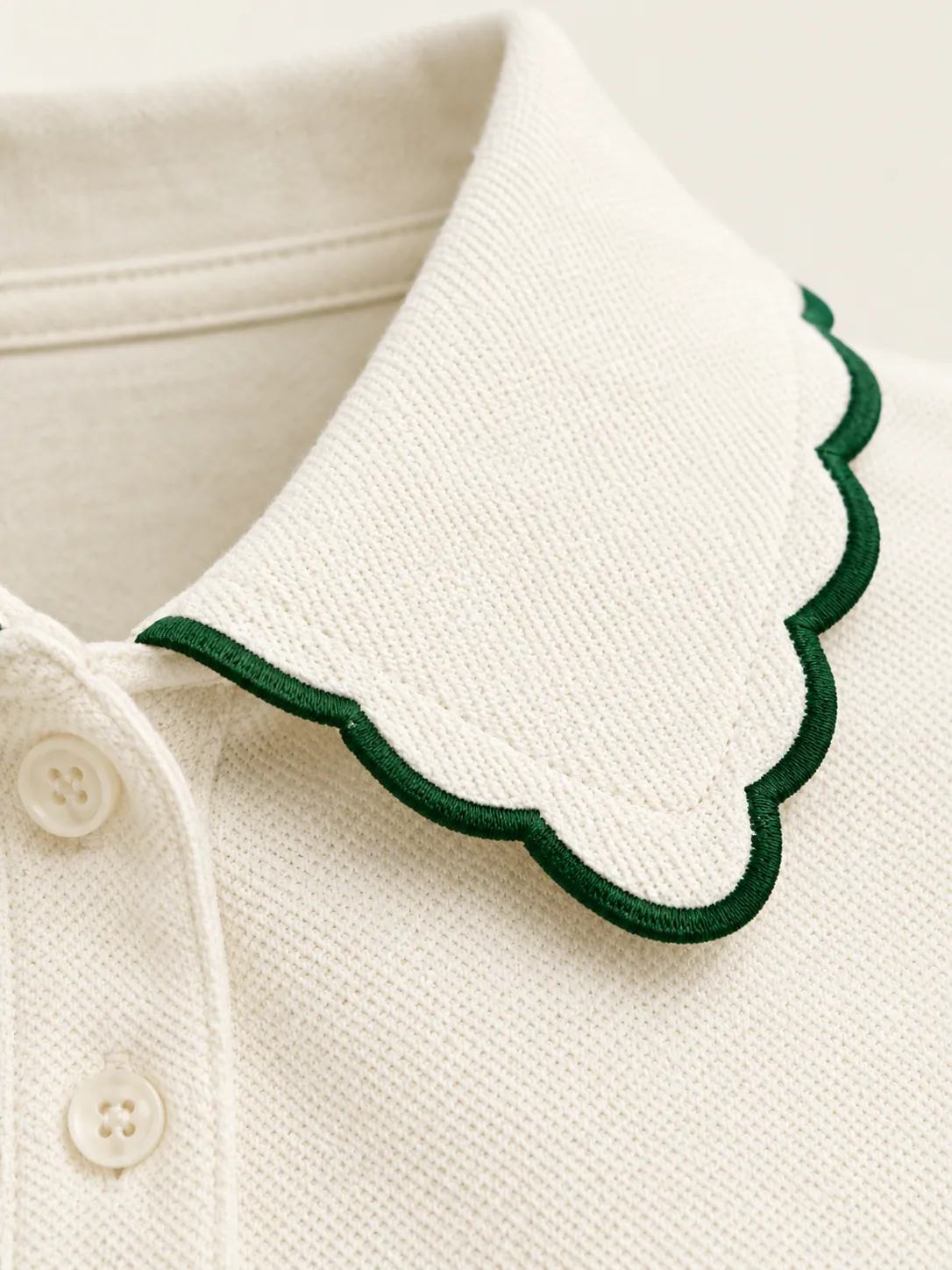 Ace Scallop-Collar Polo, close-up of the green-outlined scalloped collar edge