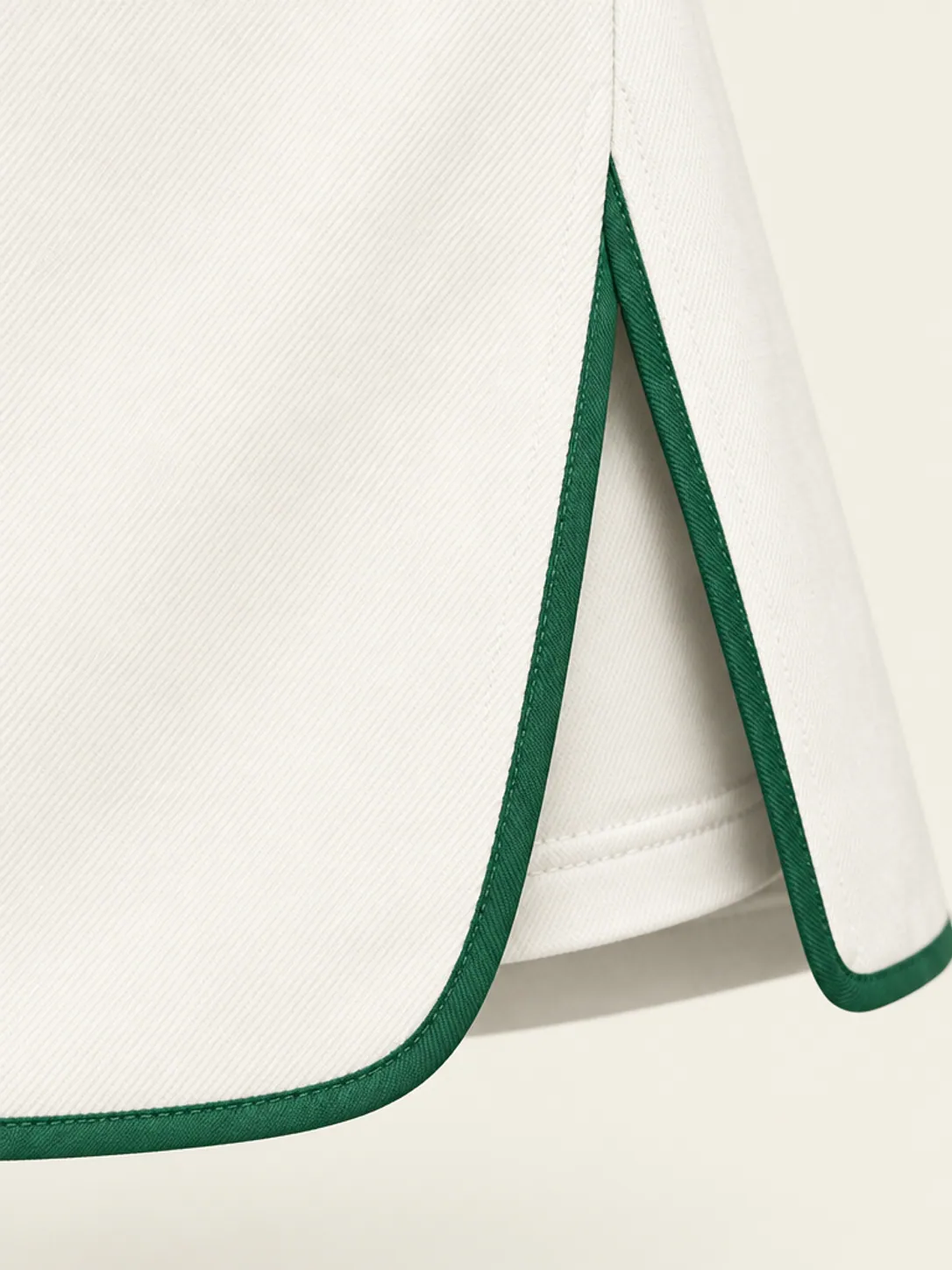 Baseline Bound-Hem Skort, close-up of the green hem binding with the inner shorts leg just visible underneath