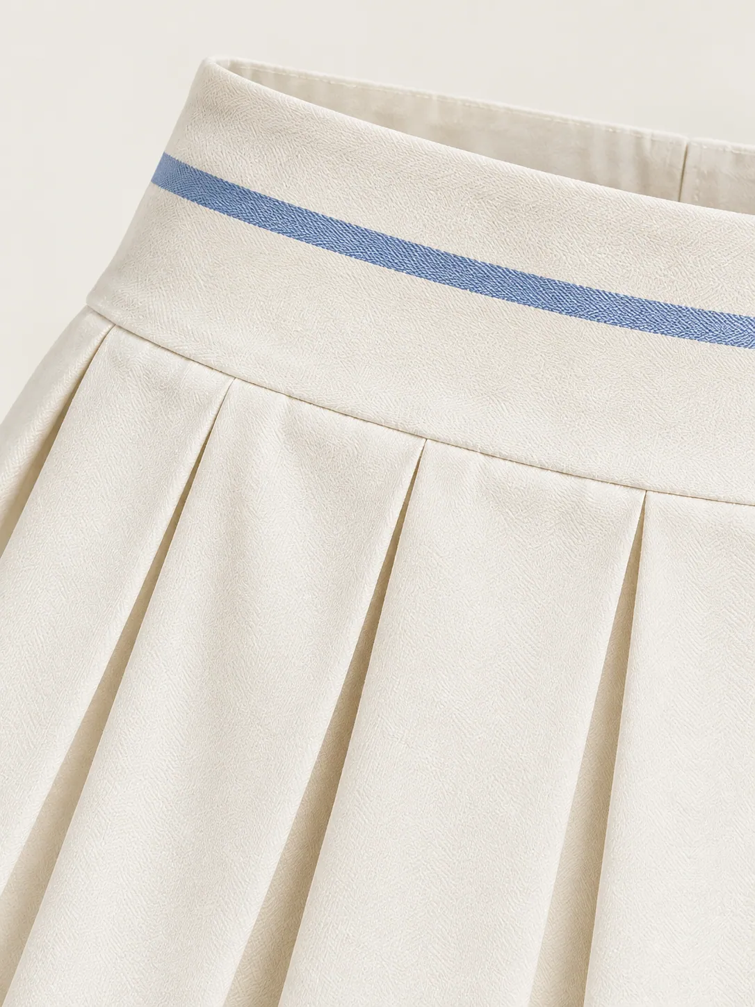 Box-Pleat Skort, close-up of the crisp box pleats and blue-striped waistband