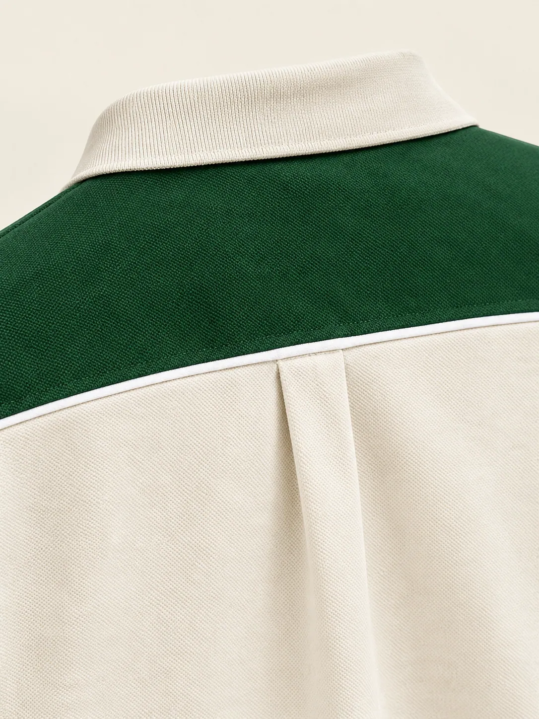 Changeover Yoke Polo, close-up of the piped yoke seam and back pleat