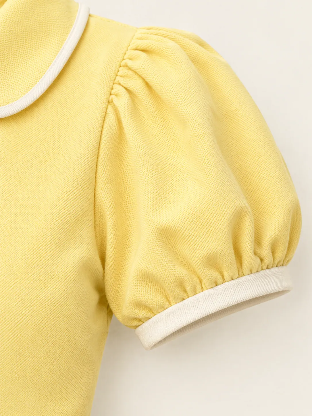 Deuce Puff-Sleeve Polo, close-up of the gathered puff sleeve with chalk binding at the cuff