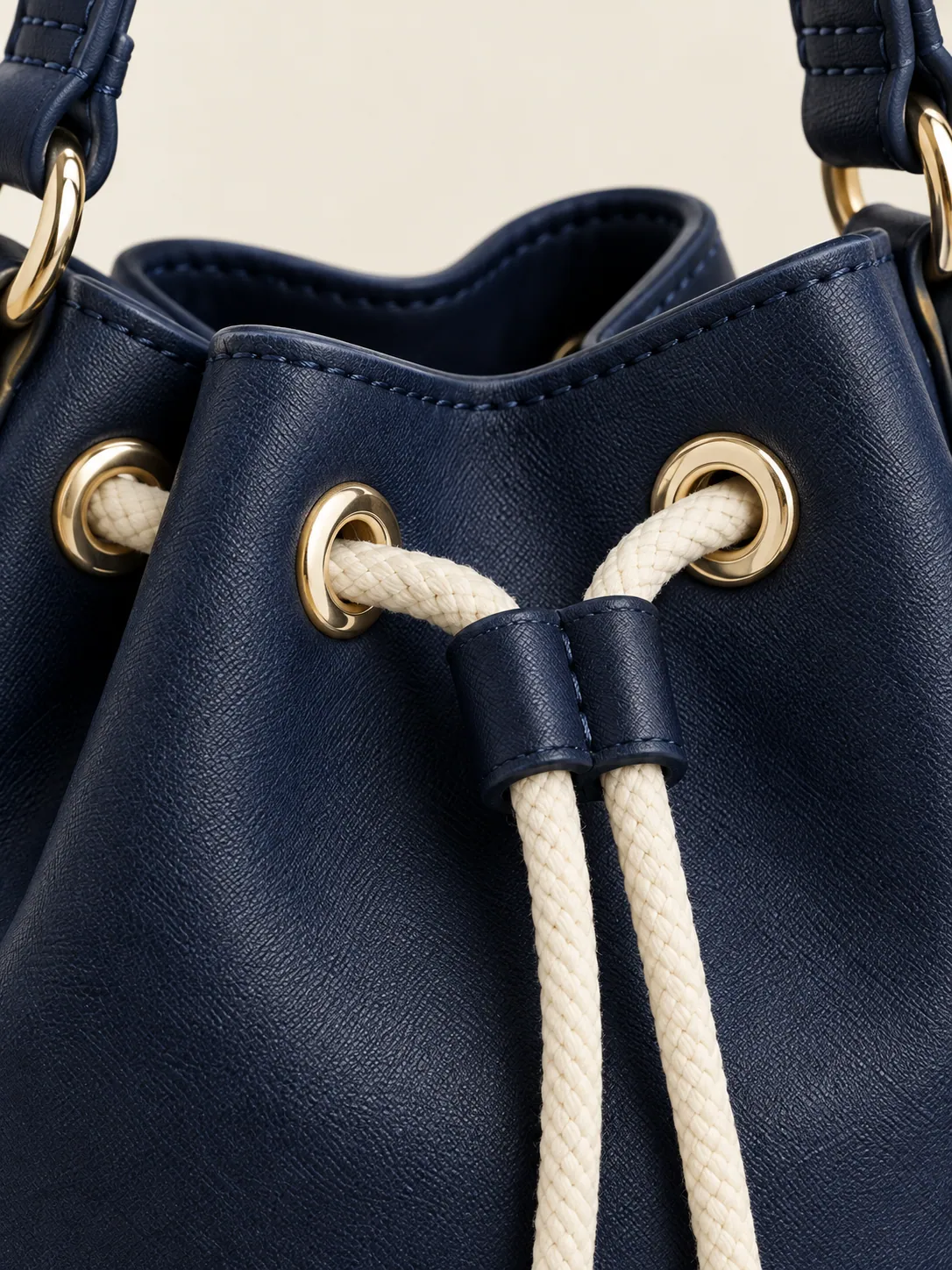 Drawstring Bucket Mini, close-up of the chalk drawstring and eyelets