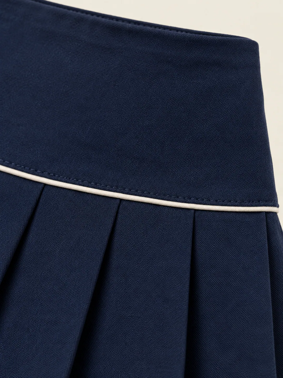Drop-Waist Pleat Skort, close-up of the chalk piping where yoke meets pleats