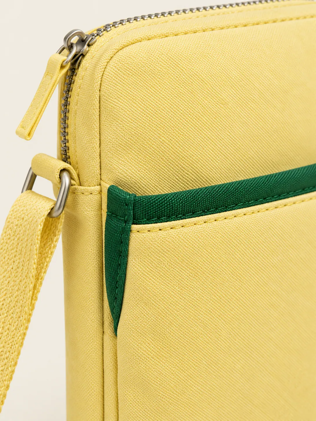 Phone Crossbody Pocket, close-up of the green-edged front slip pocket