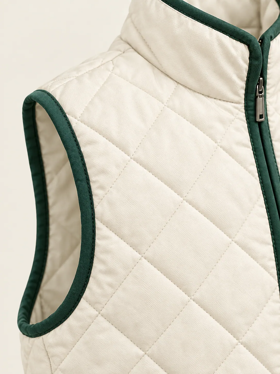 Quilted Zip Vest, close-up of the diamond quilting and green binding at the armhole