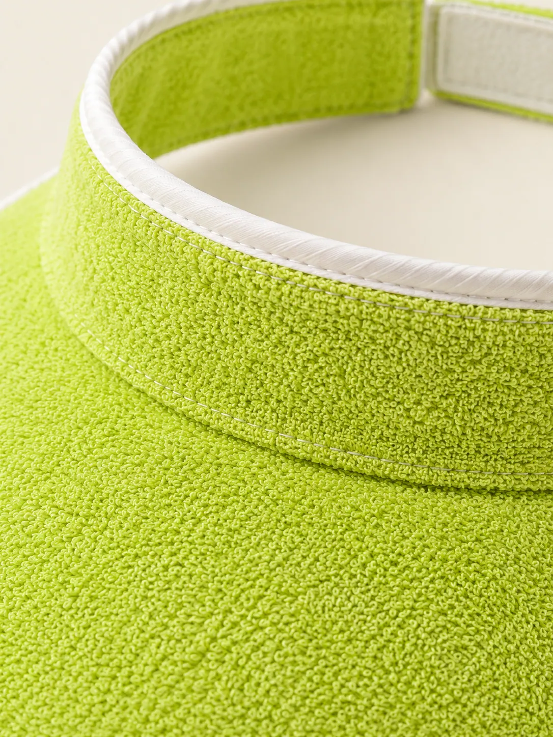 Terry Wide-Brim Visor, close-up of the terry loop texture and chalk stitching