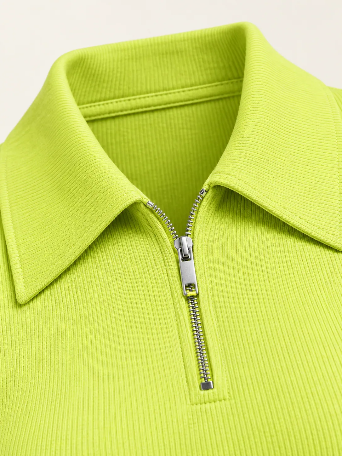 Tramline Rib Polo, close-up of the short front zip pull and long collar points