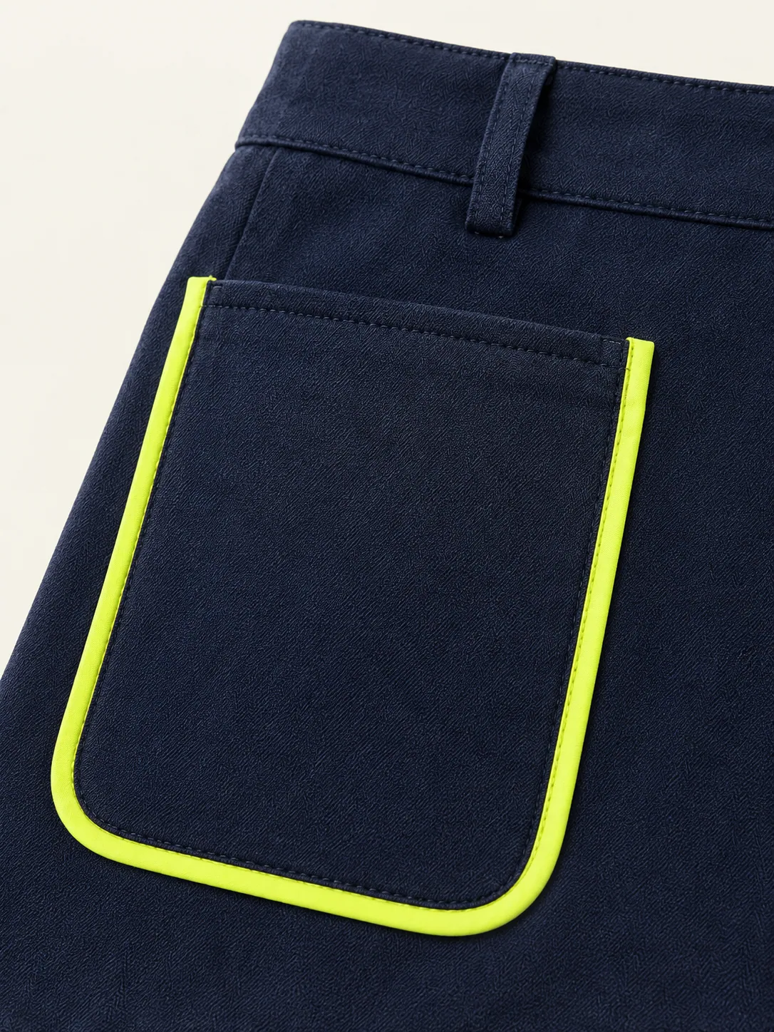 Utility Pocket Skort, close-up of the lime-edged patch pocket and belt loop