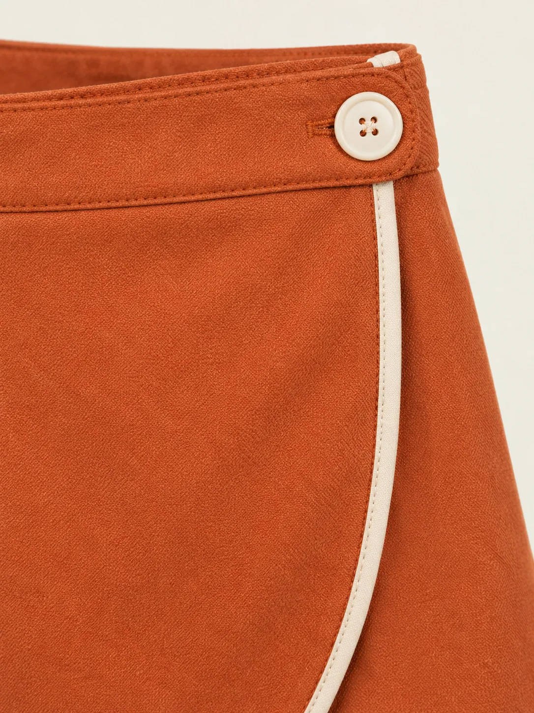 Wrap-Front Skort, close-up of the chalk button tab on the wrap overlap