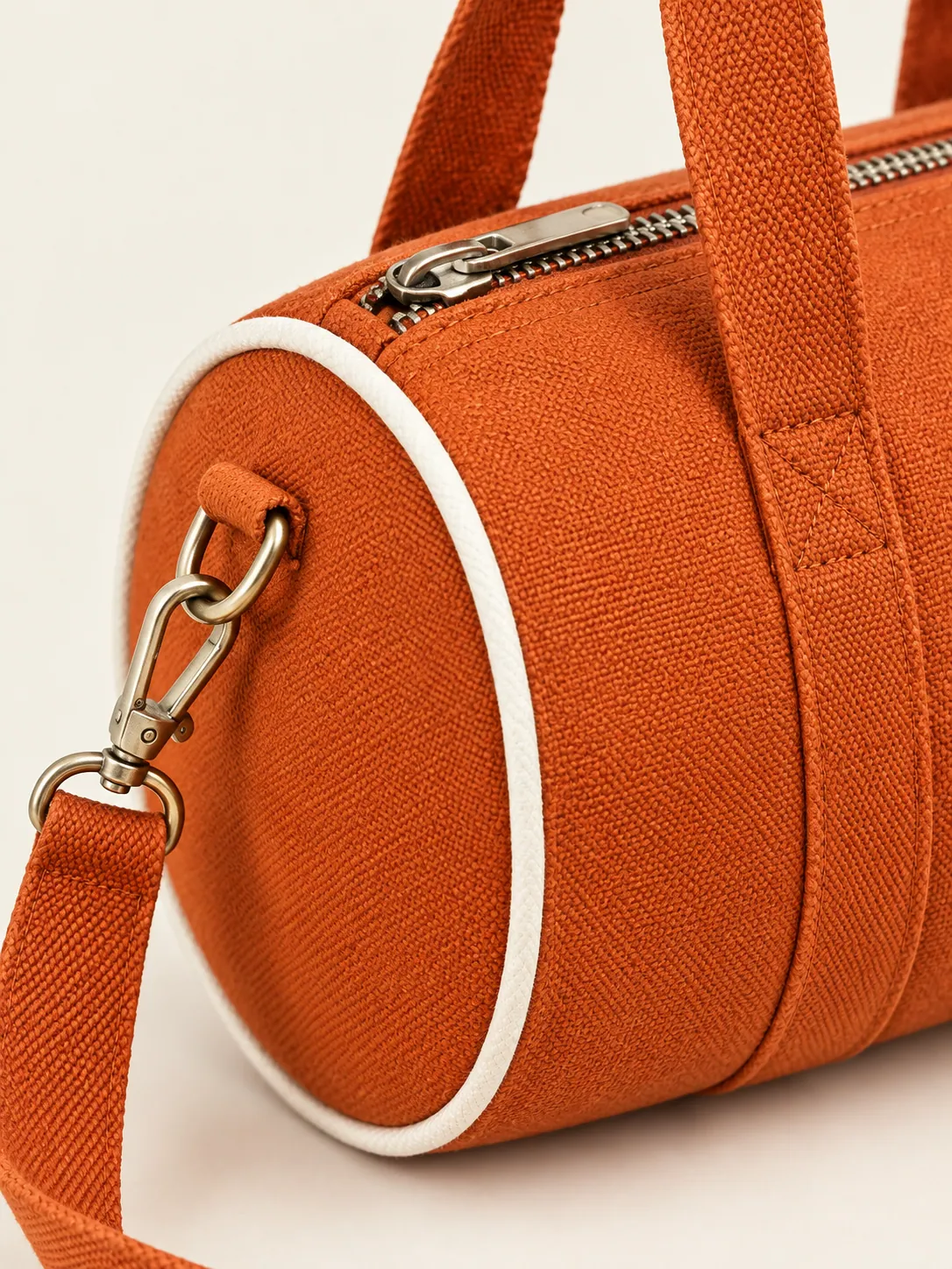 Zip Barrel Mini Bag, close-up of the round end panel and top zip